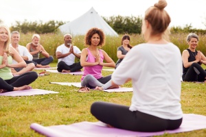 women Teaching Yoga outside 