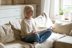 older women doing a at home yoga sequence