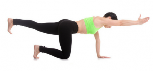 women who is holding one arm pose in a green top learning yoga poses for core strength