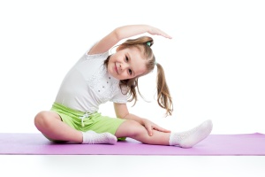 little girl learning from someone who has learned teaching children yoga