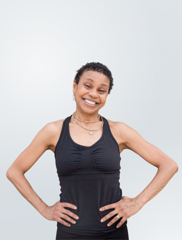 Julie Pasqual of YogaRenew standing with her hands on her hips, smiling