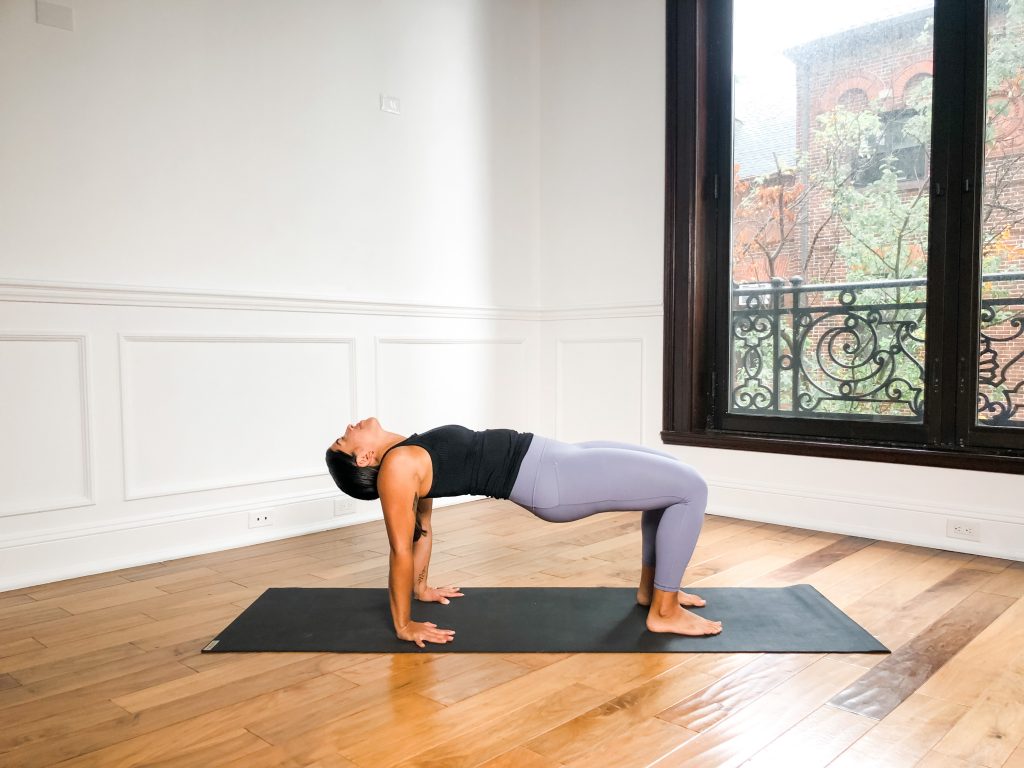 Girl in Reverse Table Top pose on a yoga mat