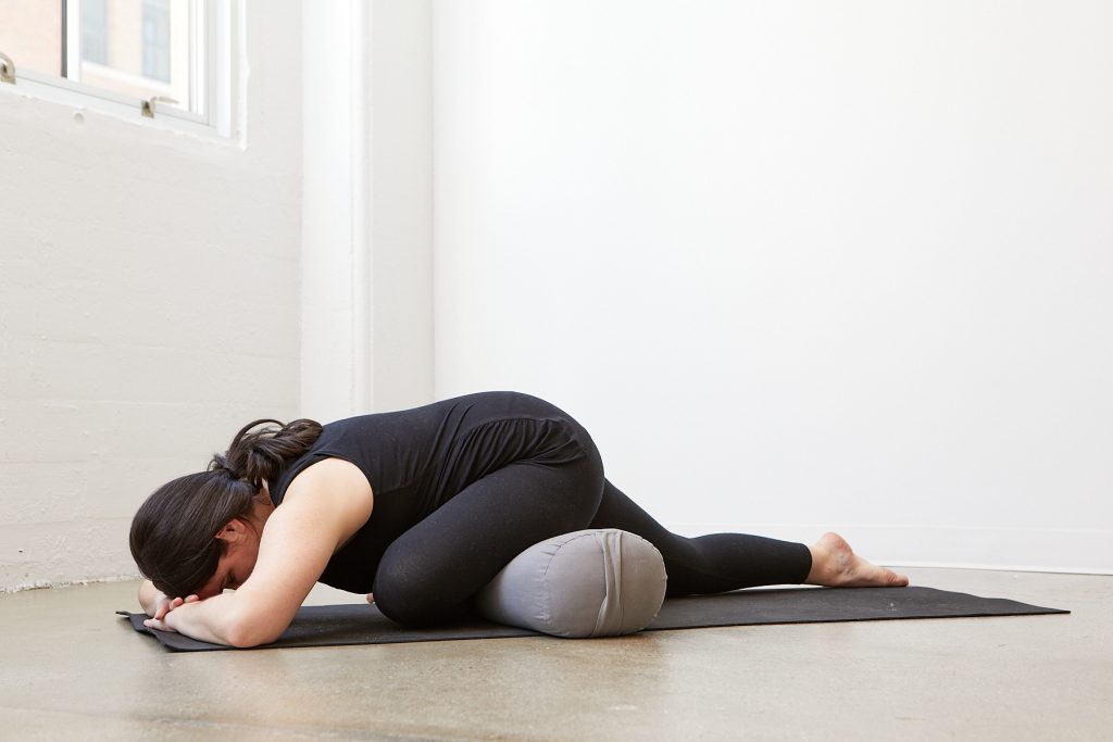 Pregnant yogi in pigeon pose